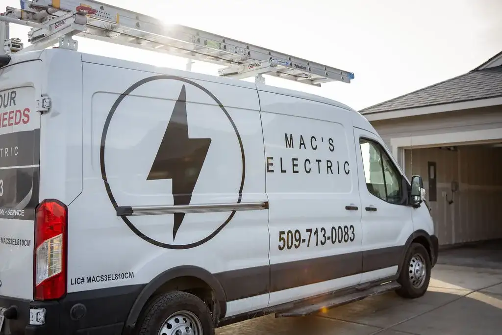 The MAC's Electric work van, with the bolt logo and phone number on the side